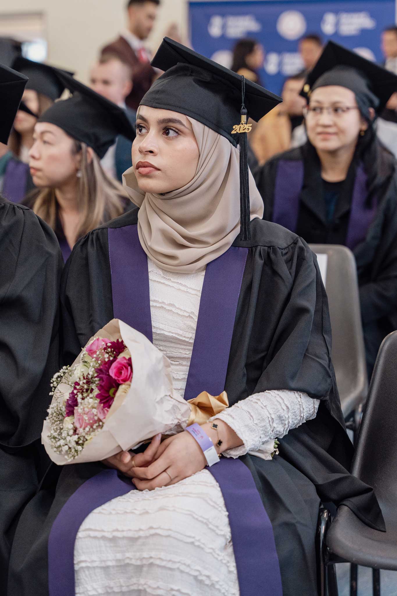 Graduates holding flower bouquet in the Graduation ceremony of Forward Academic Team